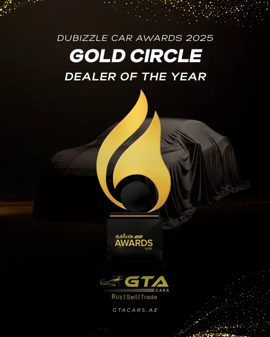 Gold Dubizzle Cars Awards 2025 trophy standing in front of a covered car, marking the Gold Circle Dealer of the Year award won by GTA Cars