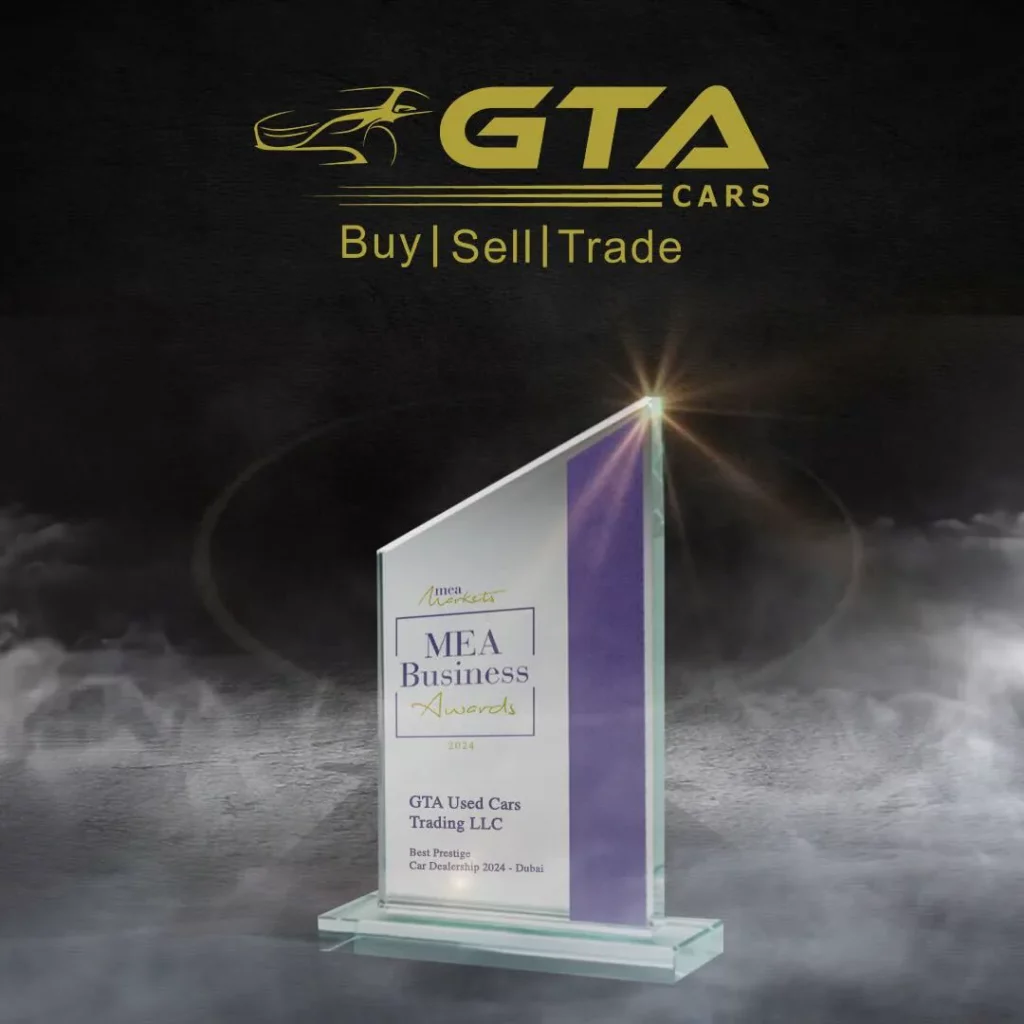 MEA Business Awards 2024 glass trophy engraved “GTA Used Cars Trading LLC — Best Prestige Car Dealership 2024, Dubai”, shown beneath the GTA Cars logo