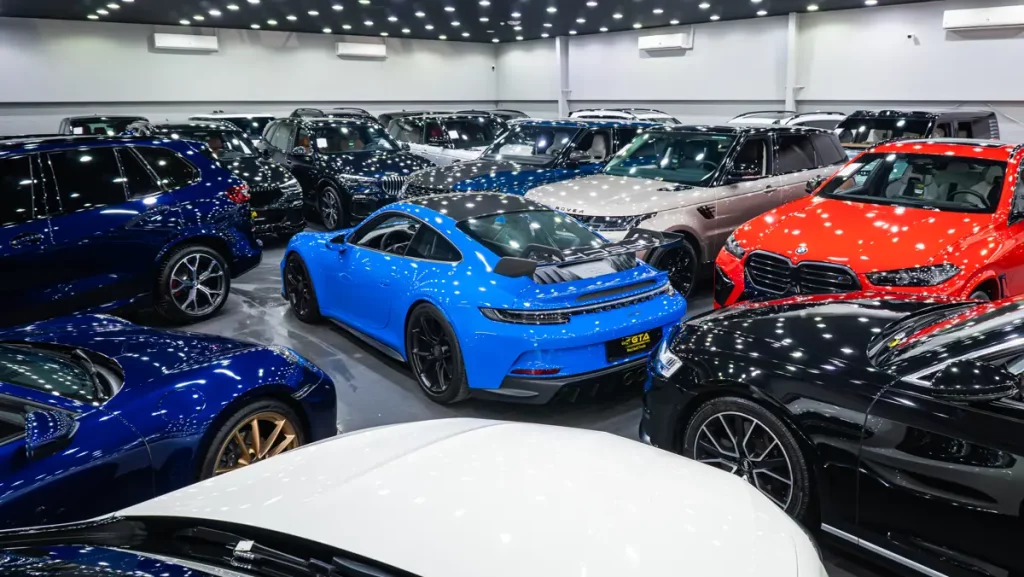 Blue Porsche 911 among pre-owned luxury cars in the GTA Cars Dubai showroom