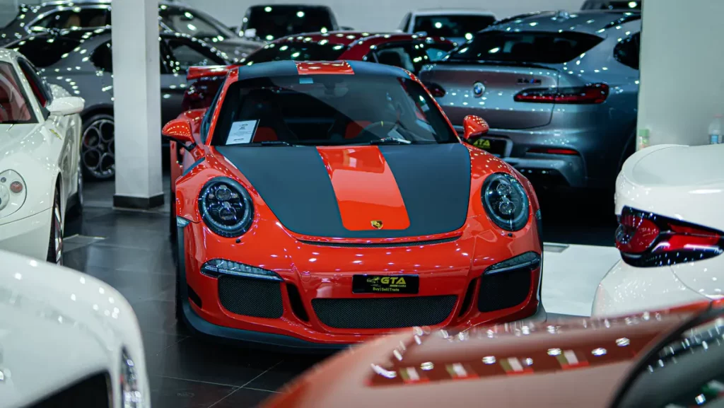 Orange and black Porsche 911 GT3 RS in the GTA Cars Dubai showroom