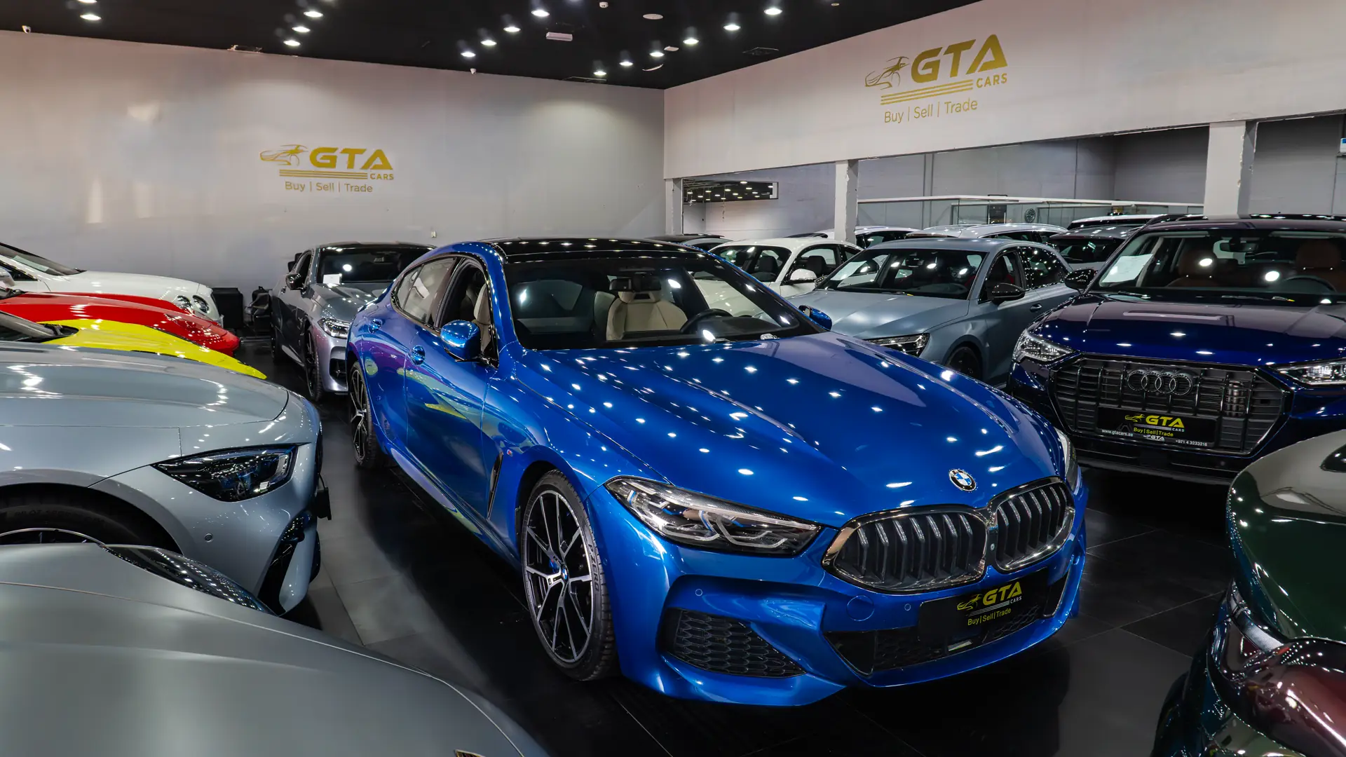 Blue BMW 8 Series coupe on the GTA Cars showroom floor in Dubai