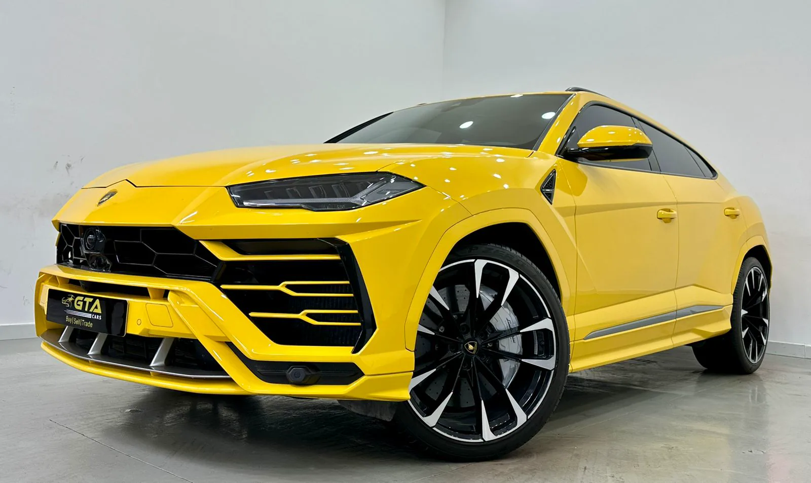 A yellow Lamborghini Urus parked outside the GTA Cars showroom in Al Quoz, Dubai